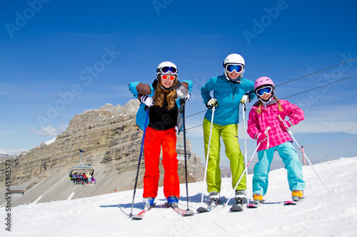 Skiing, winter sports - skiers in Dolomites, Italy