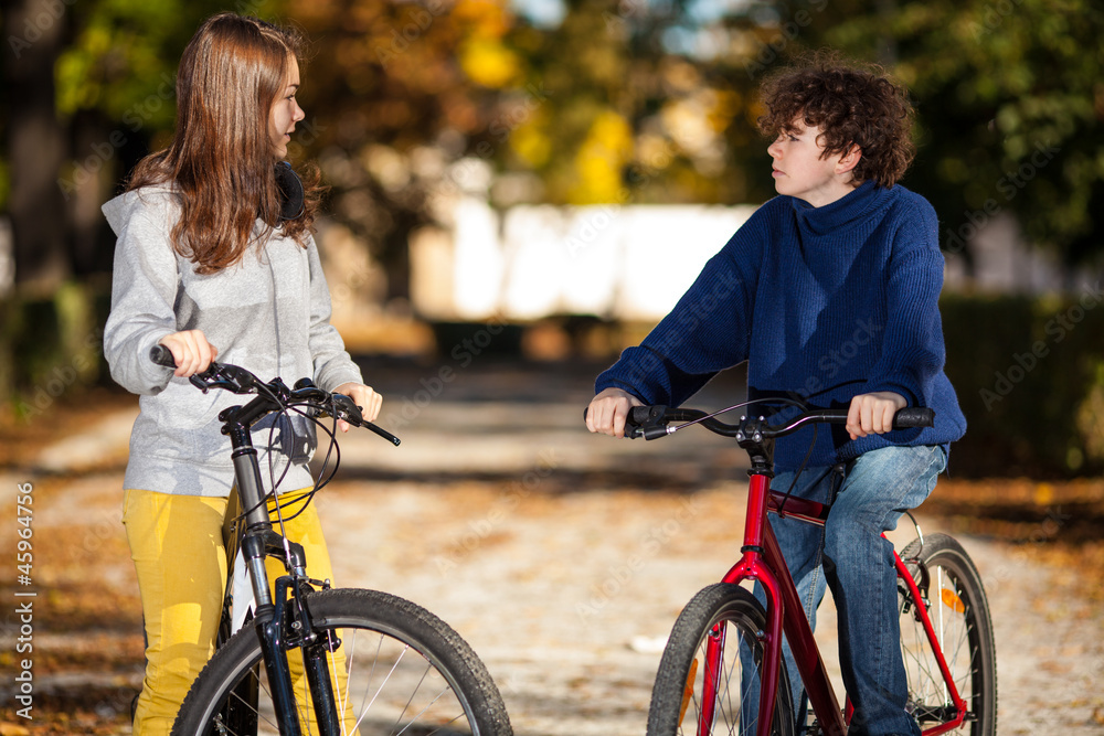 Fototapeta premium Urban biking - teens riding bikes in city