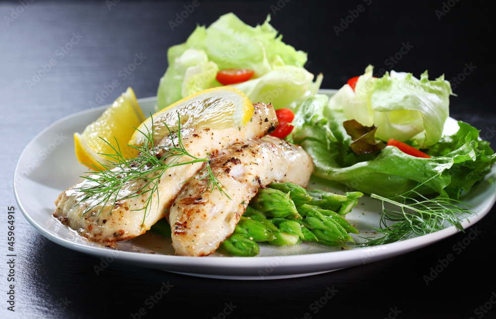 Fish on green asparagus with salad Fish on green asparagus with salad