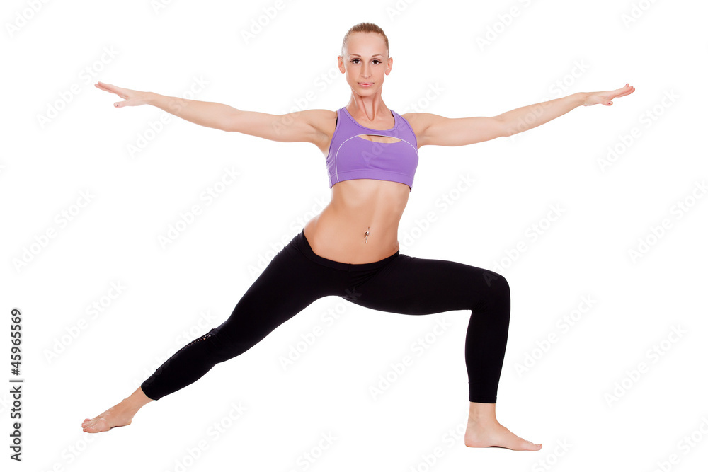 Young yoga woman doing warrior pose