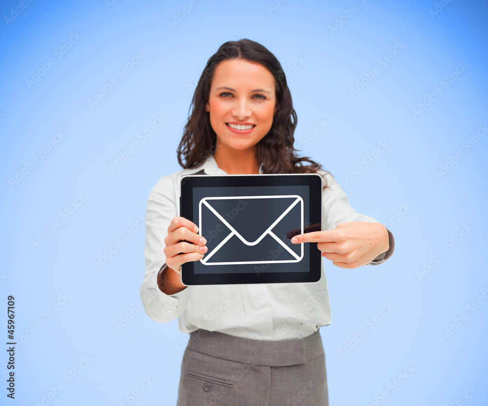 Businesswoman smiling and pointing to mail symbol Businesswoman smiling and pointing to mail symbol