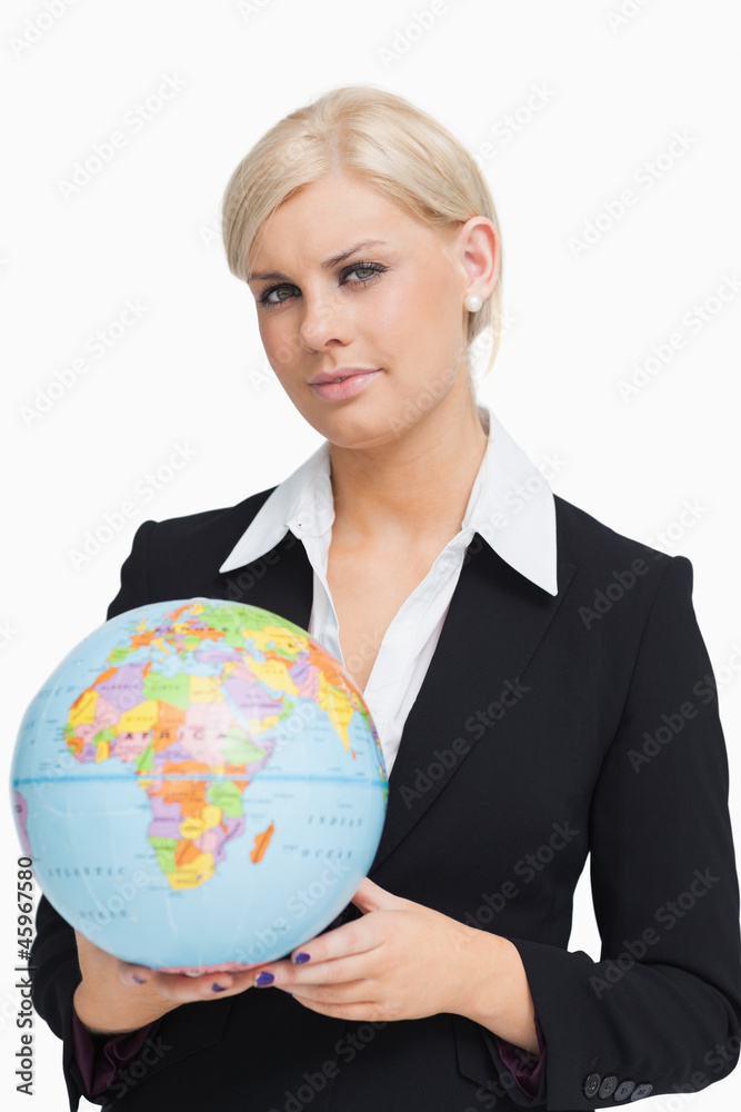 Serious businesswoman holding a globe Serious businesswoman holding a globe