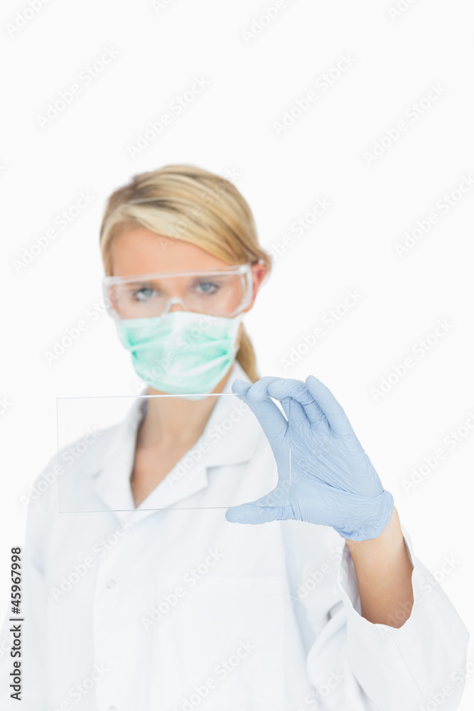 Surgeon looking through clear pane
