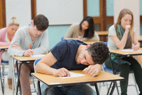 Fotografi Man sleeping in exam hall