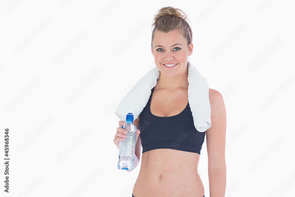 Woman smiling while holding a bottle of water Woman smiling while holding a bottle of water