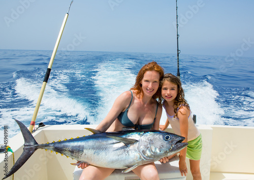 bikini fisher woman and daughter with bluefin tuna