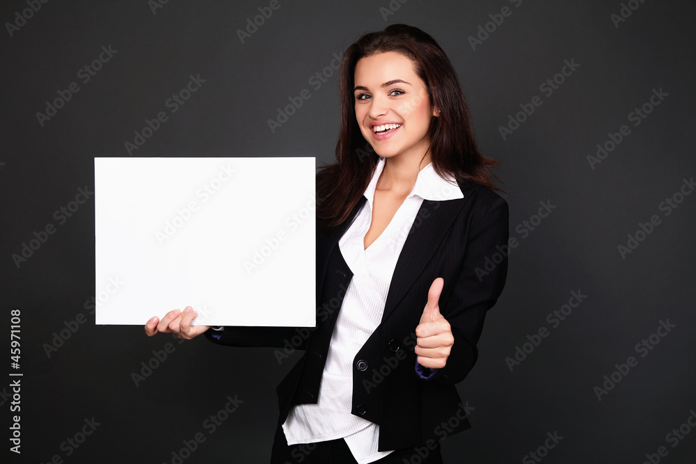Happy smiling young business woman showing blank signboard, over Happy smiling young business woman showing blank signboard, over
