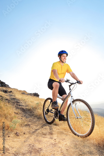 A biker riding a mountain bike on an offroad track
