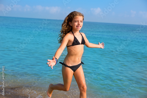 blue beach kid girl with bikini jumping and running