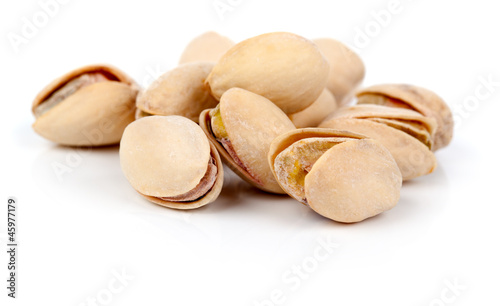 pistachios heap against white background