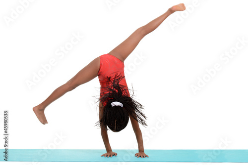 Young black girl doing gymnastics cartwheel motion blur