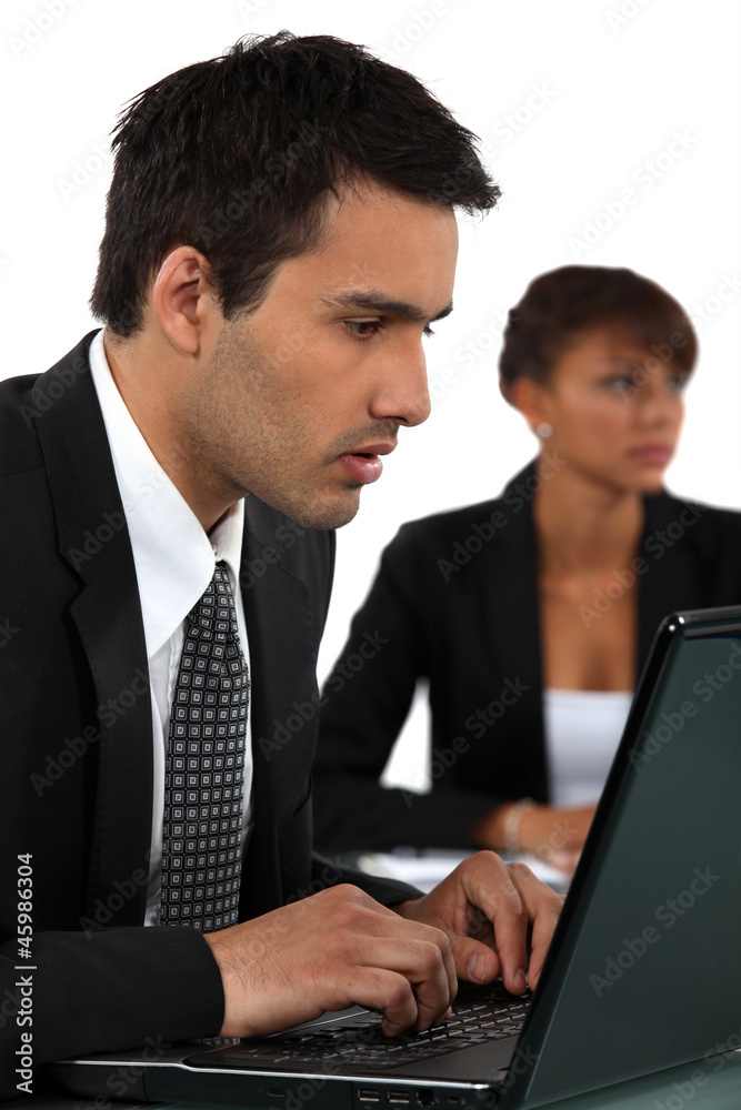 Two businesspeople rushing to get work completed Two businesspeople rushing to get work completed