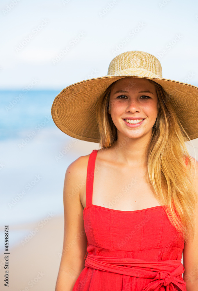 Happy Beautiful Woman in Red Dress on the Beach