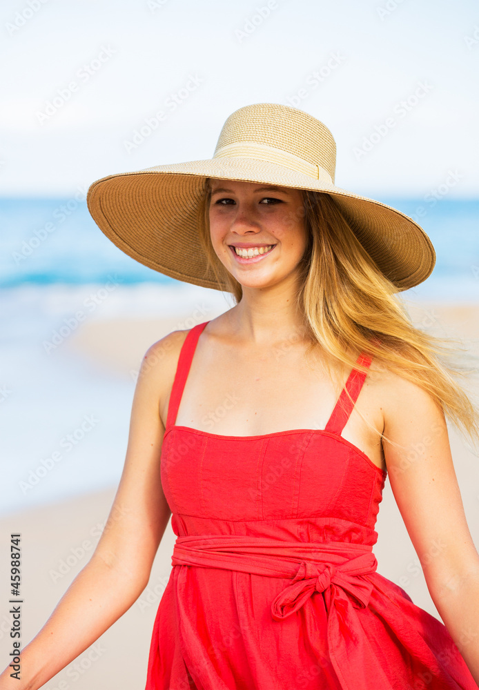 Happy Beautiful Woman in Red Dress on the Beach