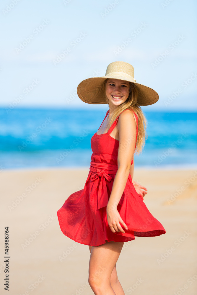 Happy Beautiful Woman in Red Dress on the Beach