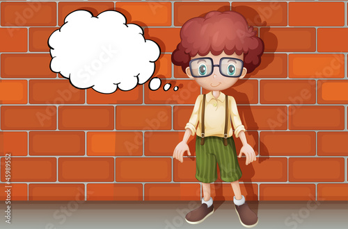 a boy thinking near wall