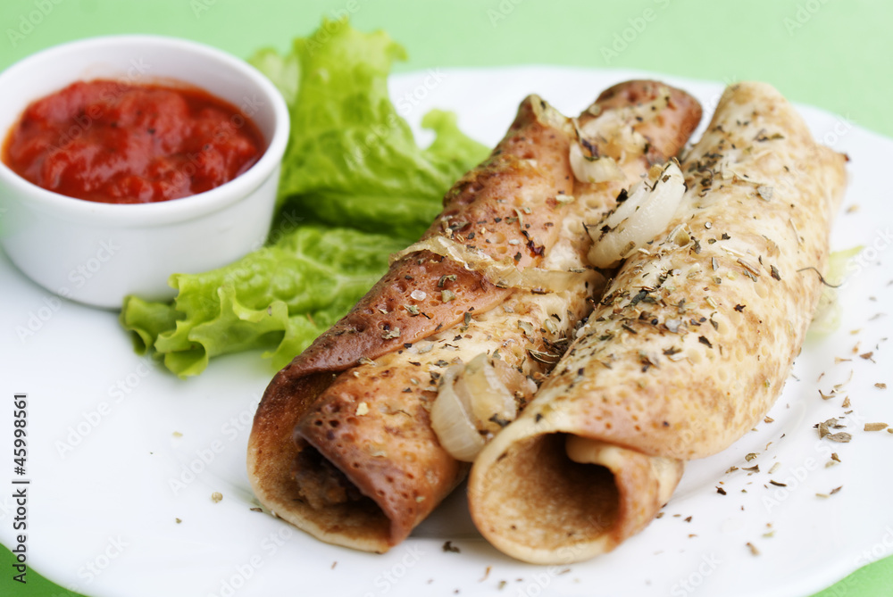 Appetizing fried pancakes with a tomato sauce Appetizing fried pancakes with a tomato sauce