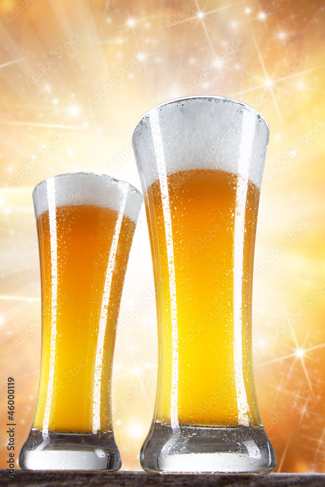 Beer in a glass with gold background 
