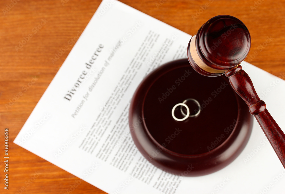 Divorce decree and wooden gavel on wooden background
