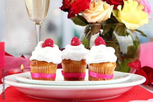 Delicious cupcakes with cream air on festive table close-up