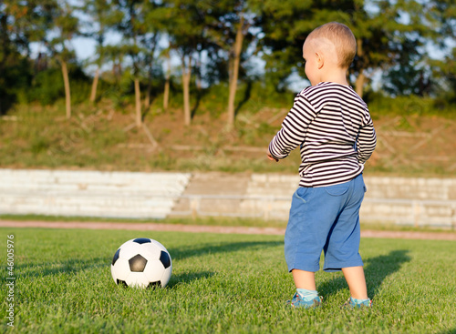 Little boy learning to play soccer