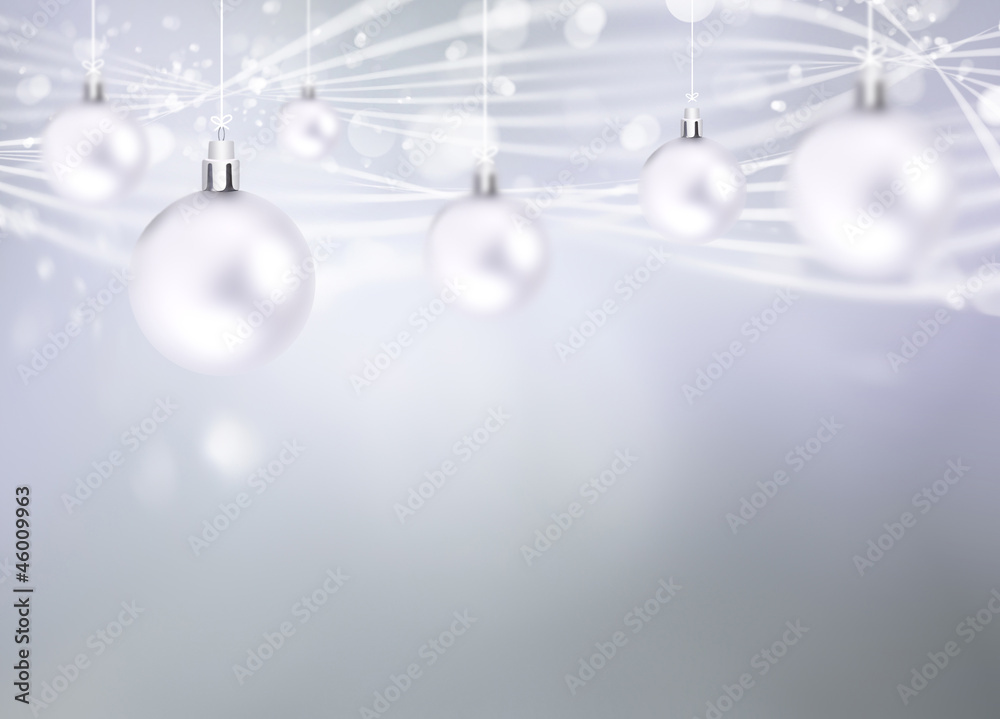 Christmas balls hanging with ribbons on abstract background