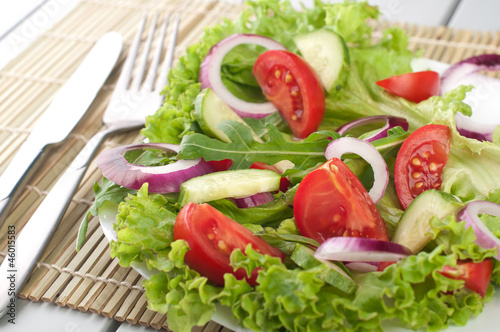 Fresh salad with cucumbers tomatoes and onions