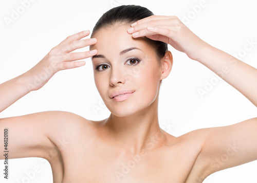 Beautiful woman cares of forehead