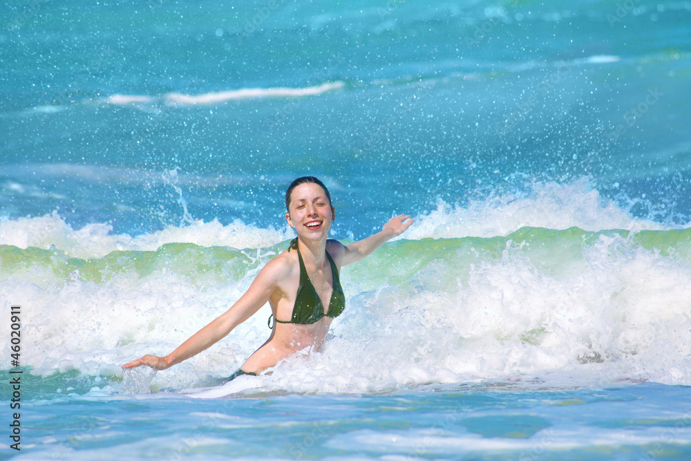 Happy girl splashing in the waves Happy girl splashing in the waves