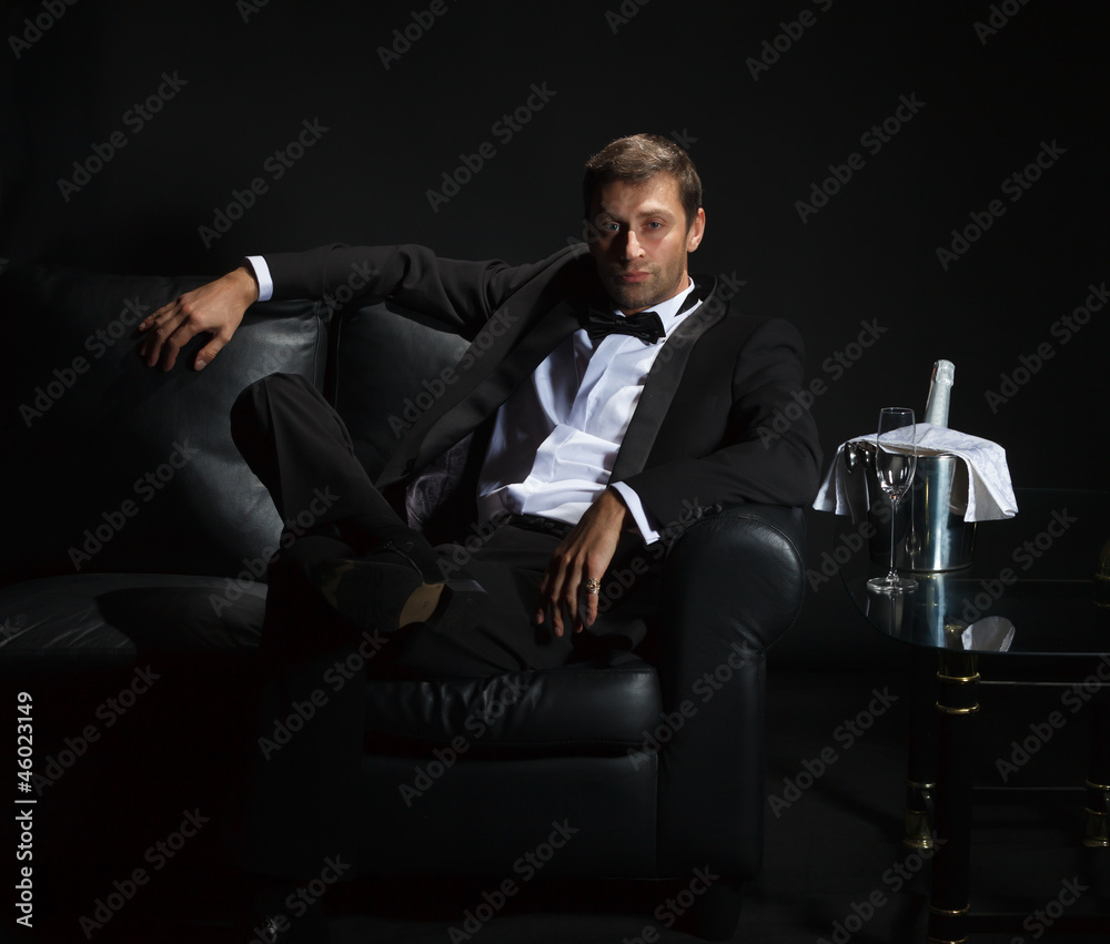 Sexy man in tuxedo waiting for his date Sexy man in tuxedo waiting for his date