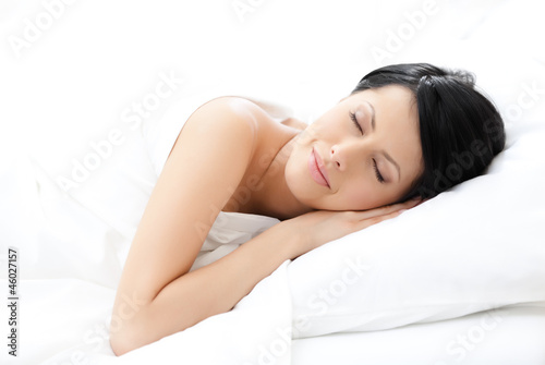 Woman sleeps in bed, white background