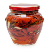 dried tomatoes in olive oil in a gass jar isolated