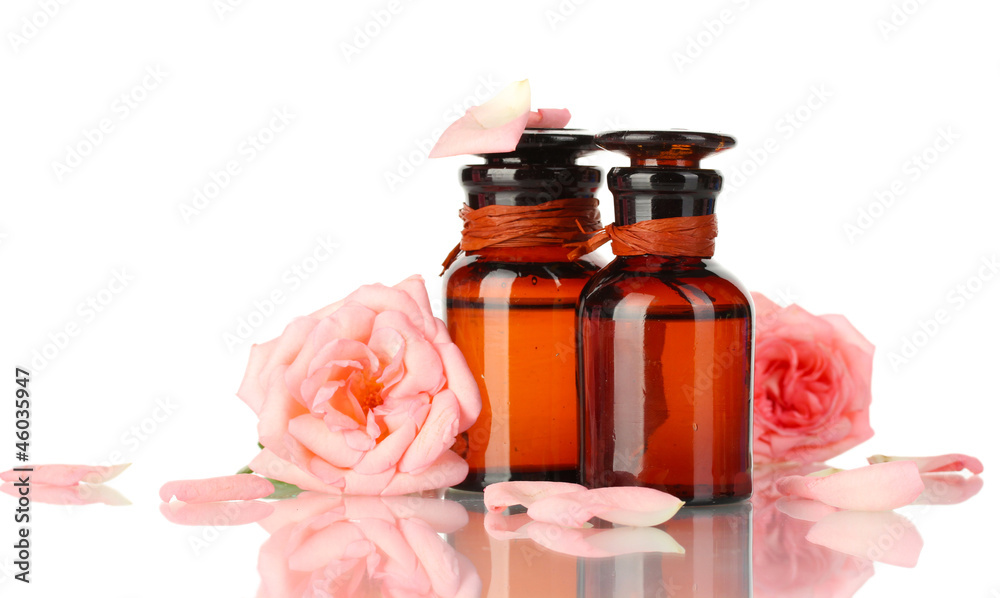 bottles of oil and roses isolated on white bottles of oil and roses isolated on white