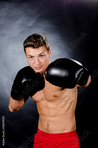 Muscular young man boxing