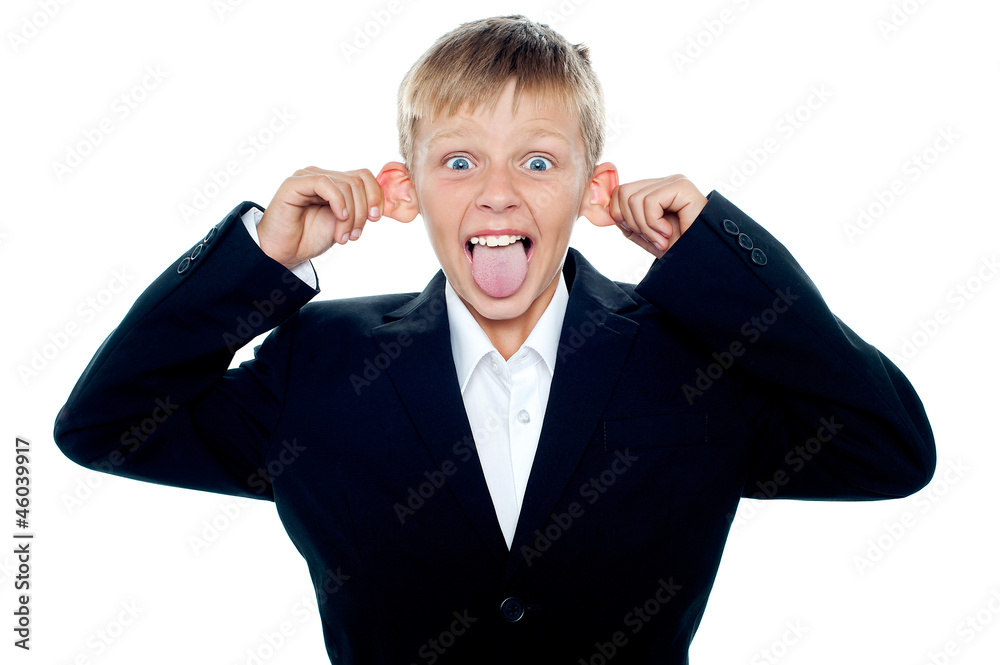 Notorious little boy making faces and teasing