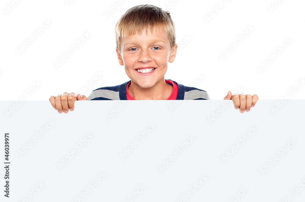 Stylish boy standing behind big blank banner ad Stylish boy standing behind big blank banner ad