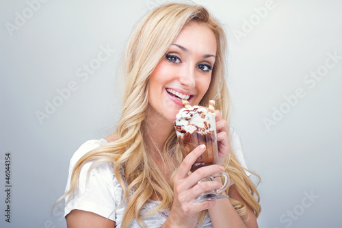 Young woman drinking ice coffe  studio-shot