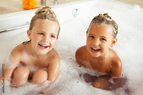 Fotografie Two Girls Playing In Bath Together