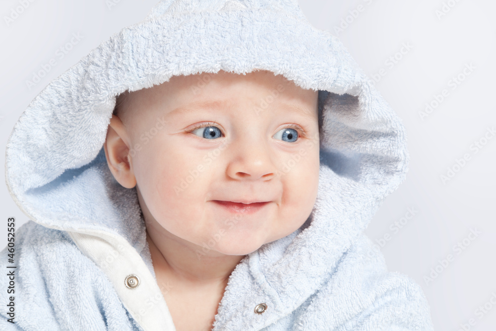 portrait of a cheerful child in blue bathrobe portrait of a cheerful child in blue bathrobe