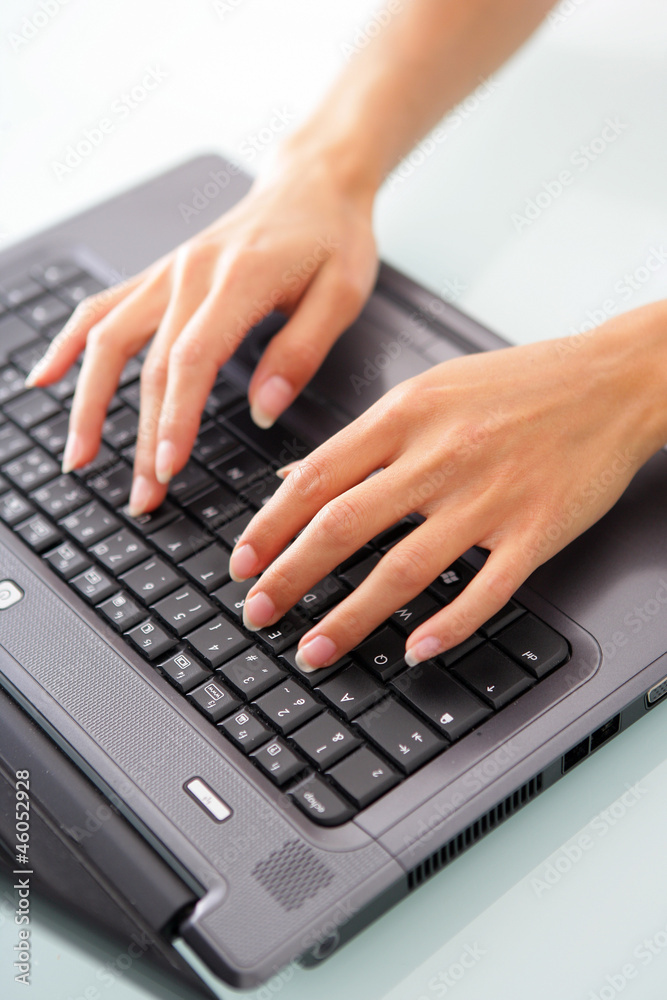 Close-up of woman typing on a laptop Close-up of woman typing on a laptop