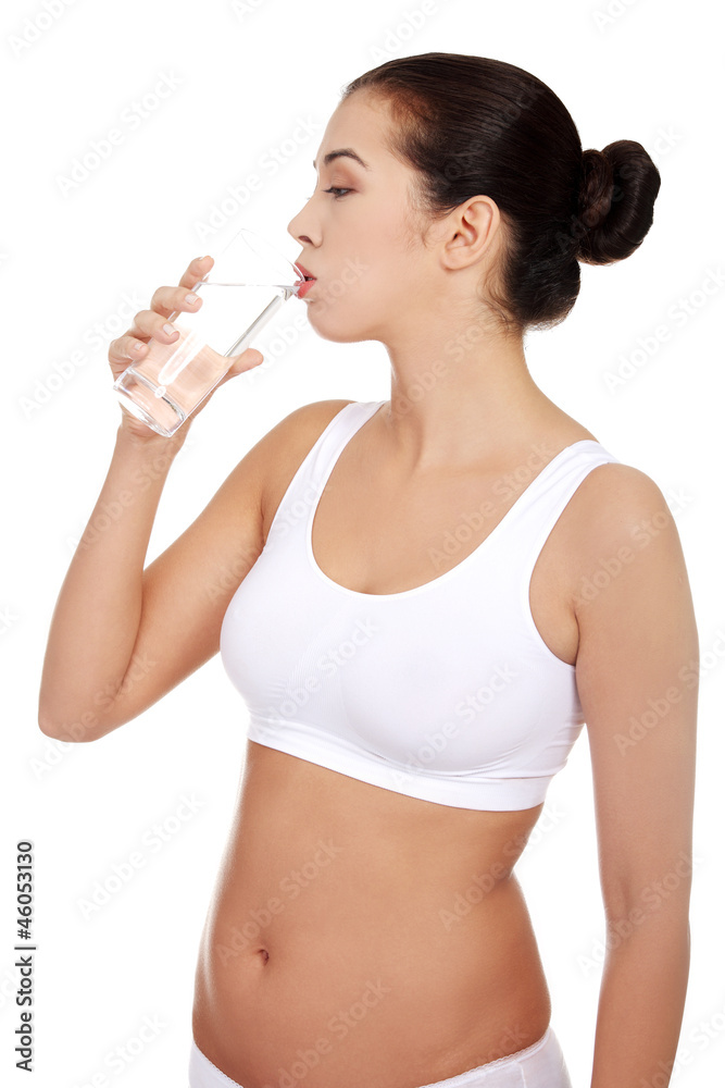 Woman in underwear with glass of mileral water Woman in underwear with glass of mileral water