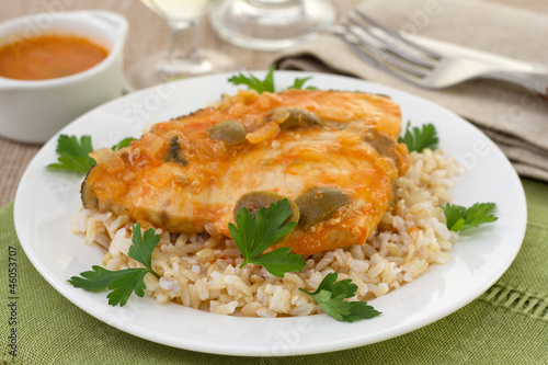 fish with boiled rice and glasses of wine and water