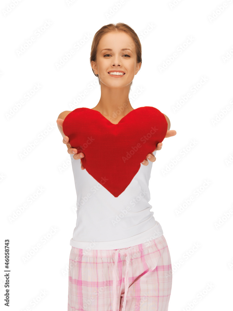 happy and smiling woman with heart-shaped pillow happy and smiling woman with heart-shaped pillow