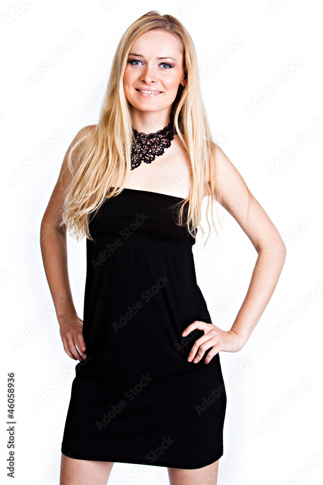 Young and beautiful woman in a black cocktail dress