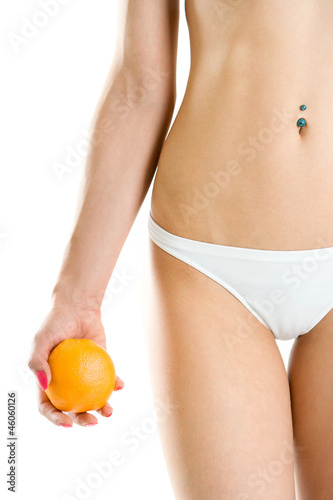 Young woman body and hand holding orange