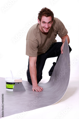 Man placing carpet photo
