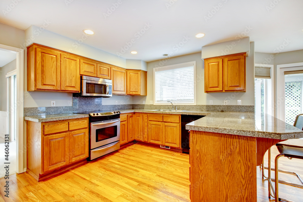New classic wood large kitchen with grey countertop. New classic wood large kitchen with grey countertop.