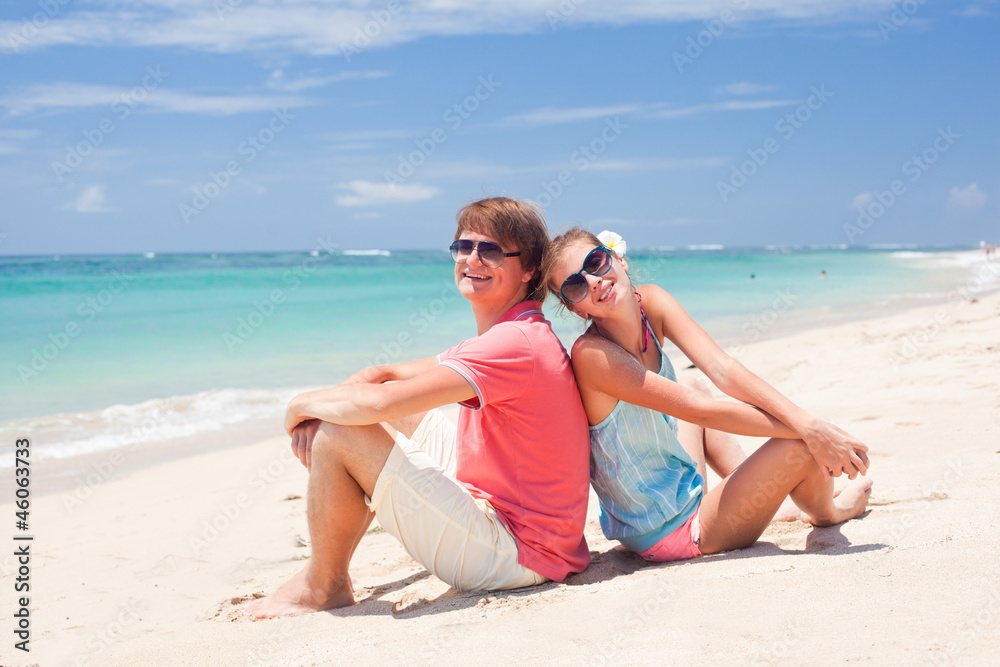 beautiful young couple sitting and having fun on beach beautiful young couple sitting and having fun on beach