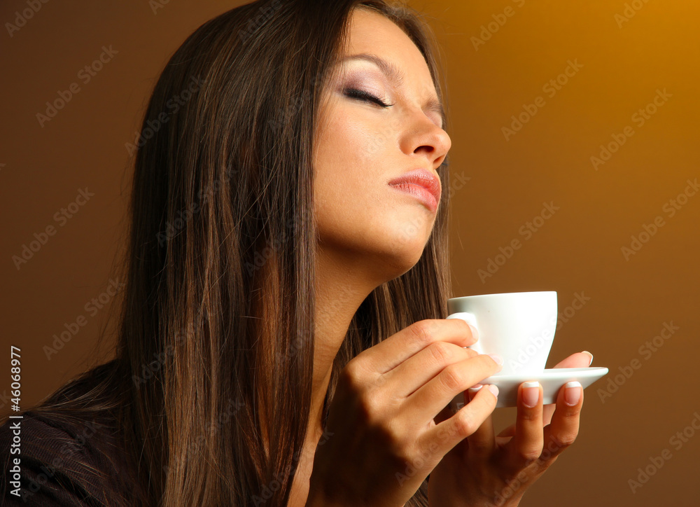 beautiful young woman with cup of coffee, on yellow background beautiful young woman with cup of coffee, on yellow background