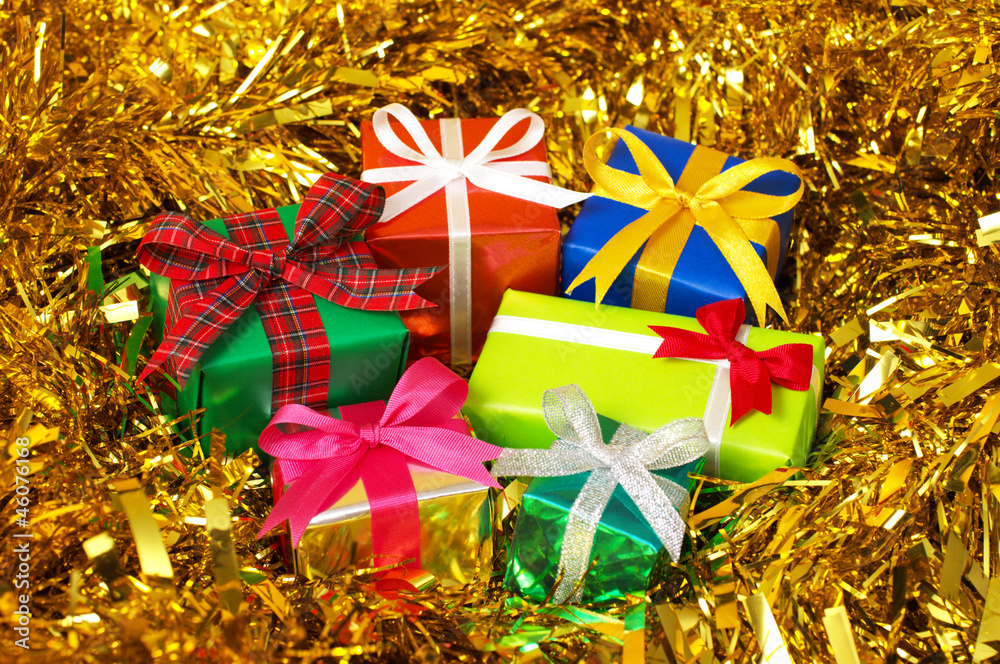 Five colorful gifts on gold tinsel.(horizontal)